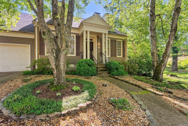 view of front of property featuring a garage and a chimney