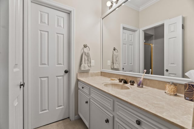 full bathroom with crown molding, a shower with door, and vanity