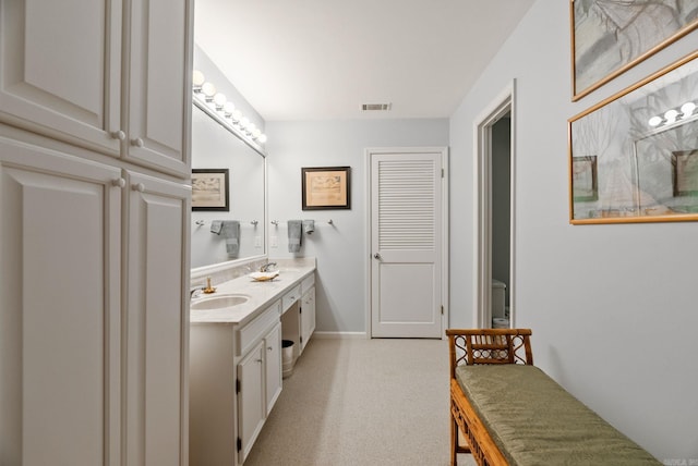 bathroom featuring baseboards, visible vents, and vanity