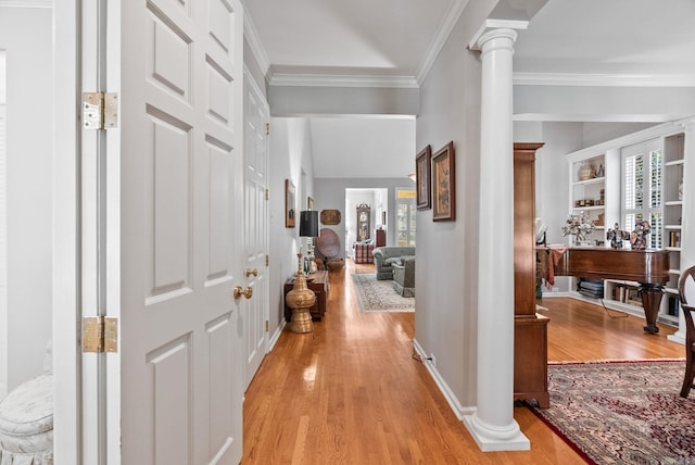 entryway with baseboards, ornamental molding, light wood-type flooring, and ornate columns