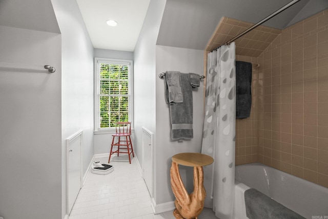 bathroom featuring baseboards, tile patterned flooring, and shower / bath combo