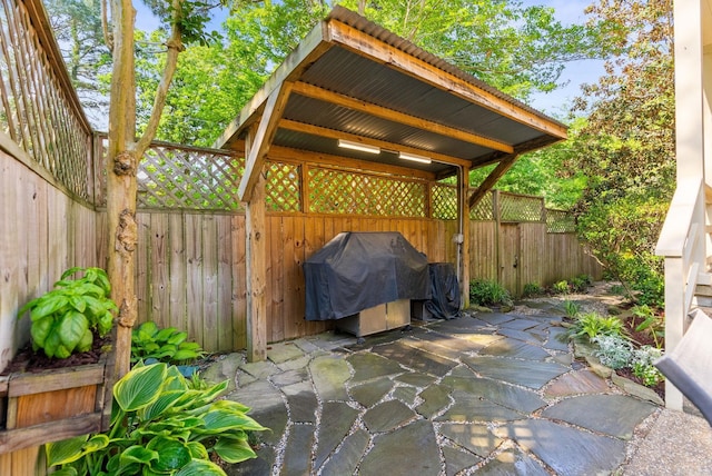 view of patio / terrace featuring area for grilling and fence