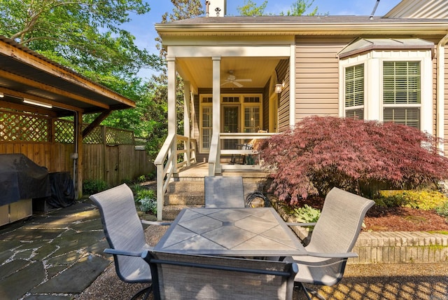 view of patio / terrace featuring fence, a ceiling fan, outdoor dining space, and a grill