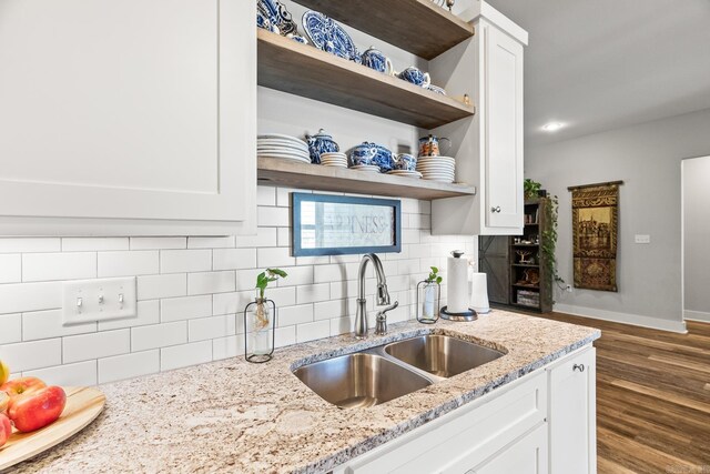 kitchen featuring a sink, open shelves, and white cabinets