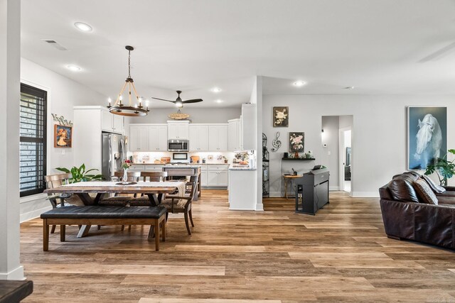 dining space featuring a chandelier, recessed lighting, baseboards, light wood-type flooring, and visible vents