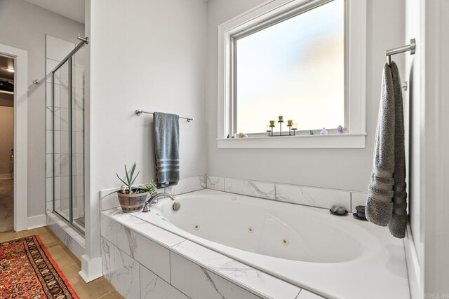 bathroom with a whirlpool tub, tile patterned floors, and a shower stall