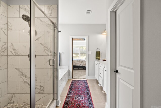 full bathroom featuring visible vents, tile patterned flooring, a shower stall, vanity, and ensuite bathroom