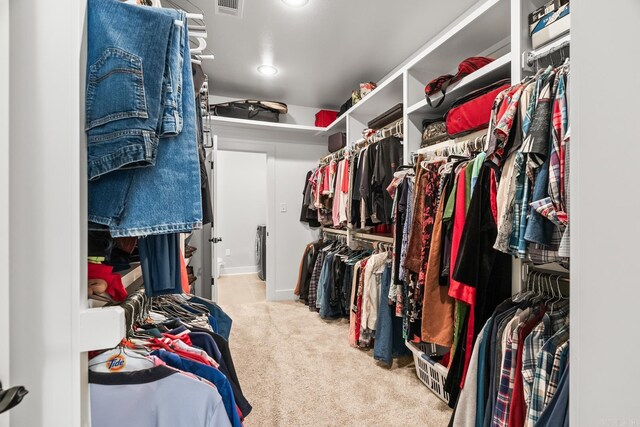 walk in closet with visible vents and carpet