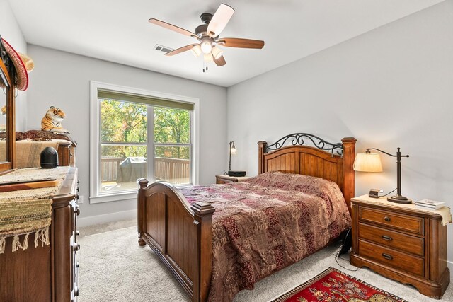 bedroom featuring baseboards, visible vents, ceiling fan, and light colored carpet