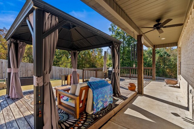 view of patio featuring fence, a ceiling fan, a wooden deck, and a gazebo