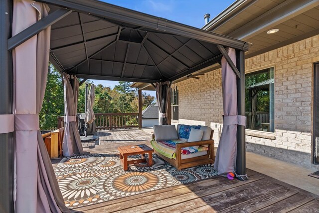 wooden deck with a gazebo and outdoor lounge area