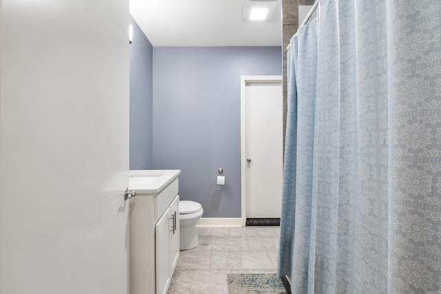 full bath with vanity, baseboards, and toilet