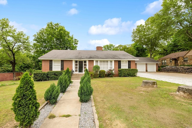 single story home with brick siding, a garage, a chimney, and a front yard