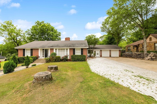 single story home featuring a chimney, a front yard, driveway, and brick siding