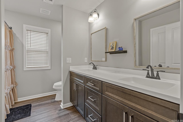 538 Maple St, Trumann, AR 72472 - full bath featuring visible vents, a sink, baseboards, and wood finished floors
