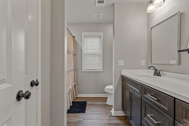 538 Maple St, Trumann, AR 72472 - full bathroom with visible vents, vanity, wood finished floors, toilet, and baseboards