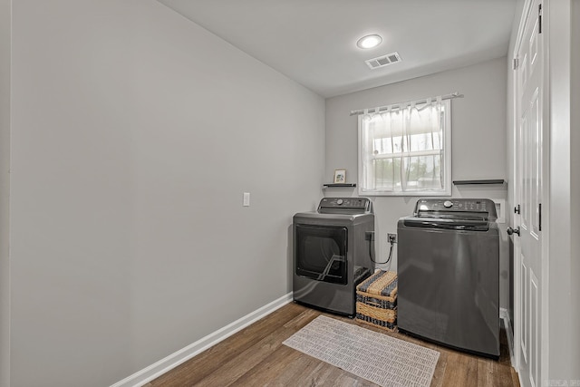 538 Maple St, Trumann, AR 72472 - washroom with laundry area, wood finished floors, separate washer and dryer, and visible vents