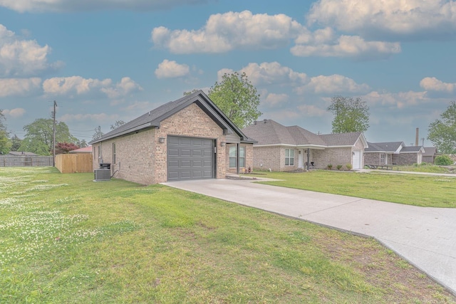 538 Maple St, Trumann, AR 72472 - ranch-style house featuring a front lawn, fence, central AC unit, an attached garage, and driveway