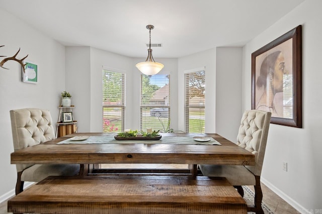 dining room with baseboards, breakfast area, and visible vents