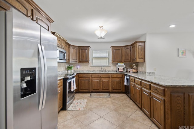 kitchen featuring a peninsula, light tile patterned flooring, recessed lighting, a sink, and stainless steel appliances