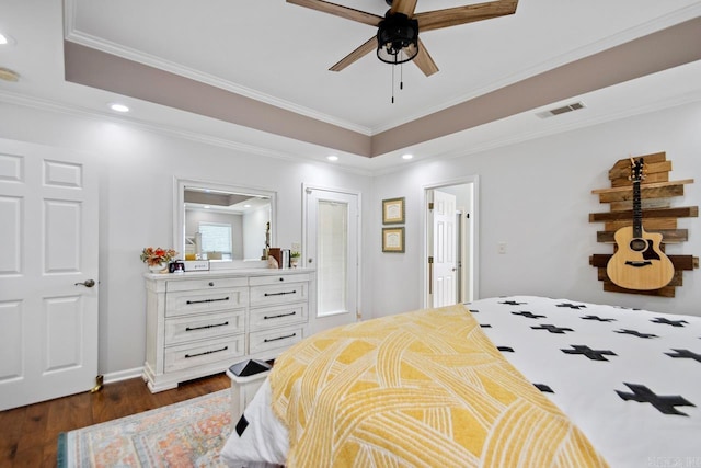 bedroom with recessed lighting, visible vents, dark wood-style floors, and a raised ceiling