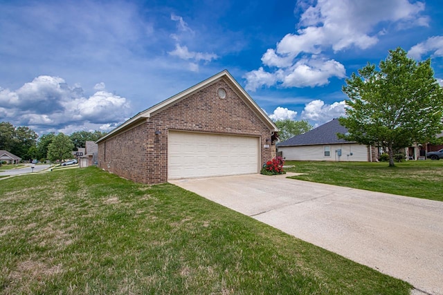 view of side of home featuring a yard and brick siding