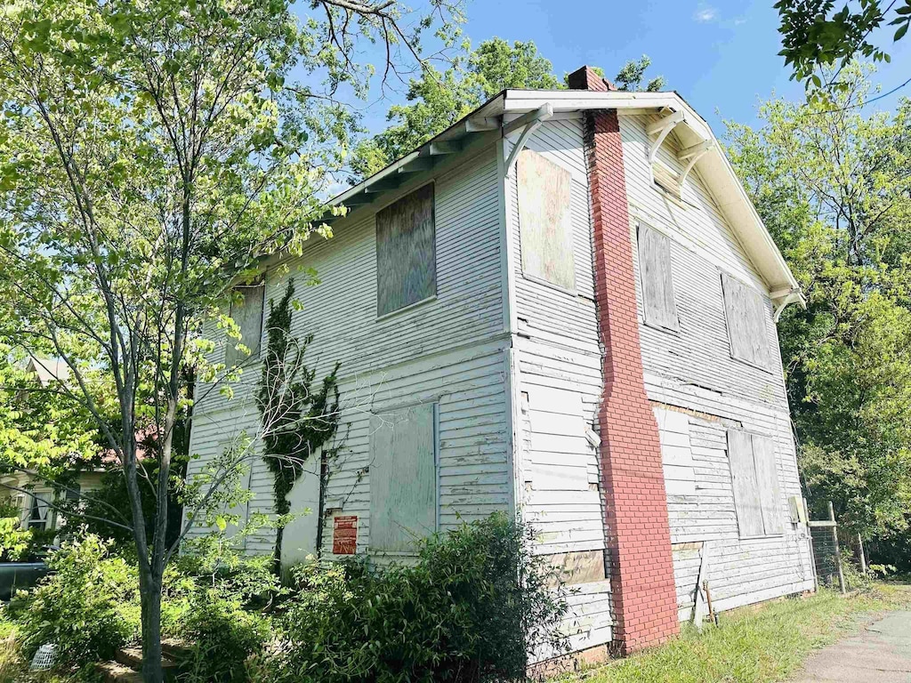 view of side of home featuring a chimney