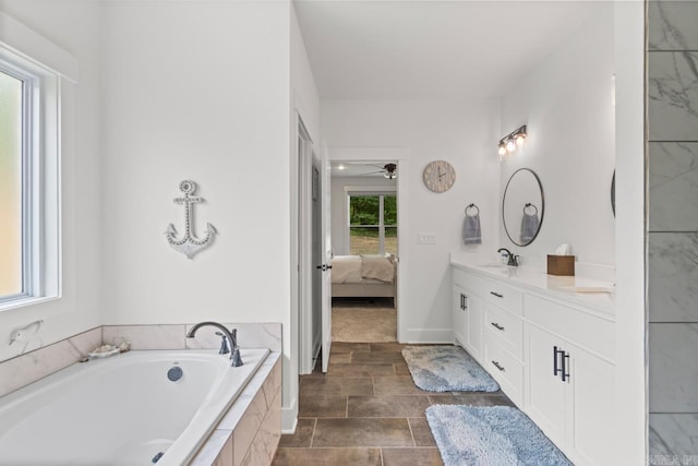ensuite bathroom with a garden tub, double vanity, ensuite bathroom, tile patterned floors, and a sink