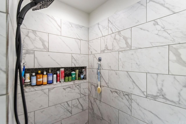 bathroom with tiled shower