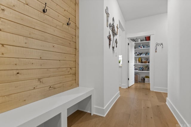 mudroom with baseboards and light wood-type flooring