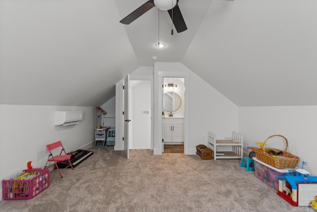 rec room featuring a ceiling fan, lofted ceiling, a wall unit AC, a sink, and carpet