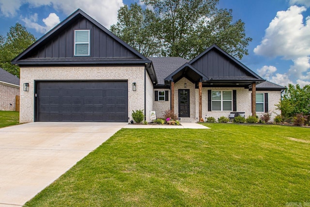 craftsman house featuring brick siding, a garage, board and batten siding, a front yard, and driveway