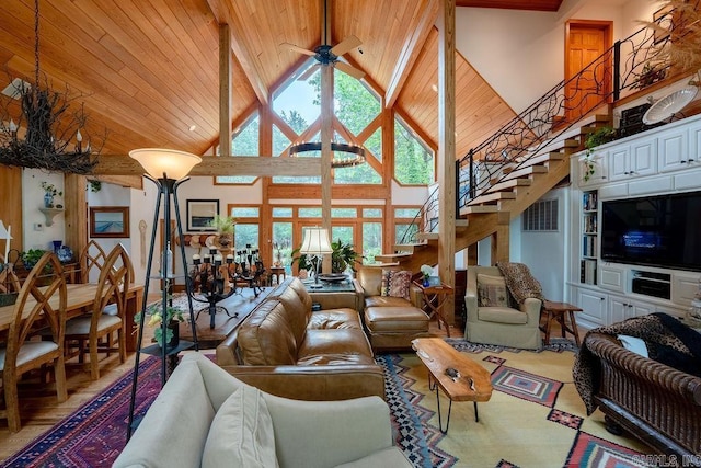 living area featuring high vaulted ceiling, stairs, a ceiling fan, wooden ceiling, and visible vents
