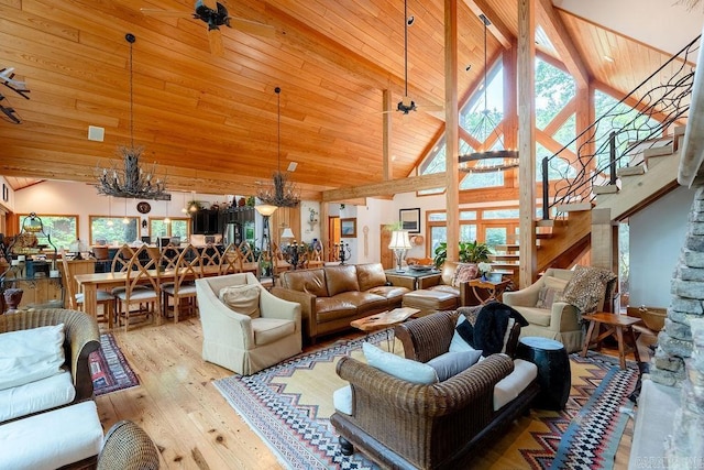 living room featuring high vaulted ceiling, a wealth of natural light, hardwood / wood-style floors, and a notable chandelier