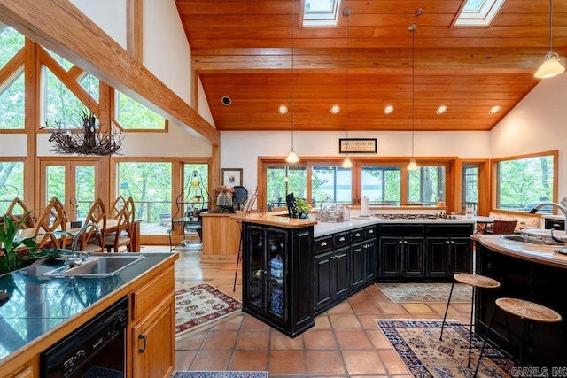 kitchen with black dishwasher, wood ceiling, dark cabinets, and a sink