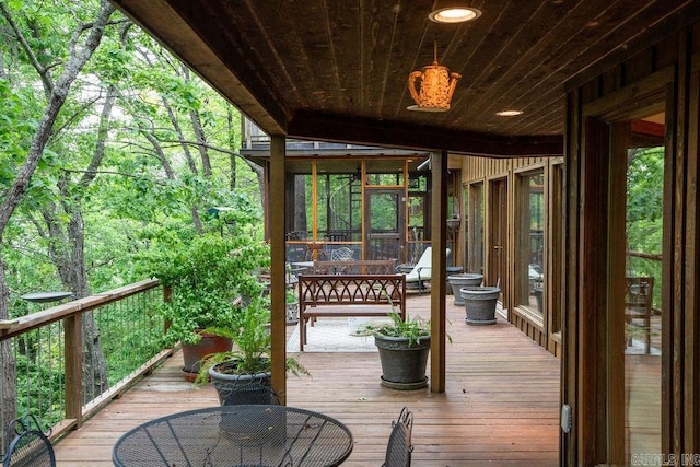 wooden deck with a sunroom