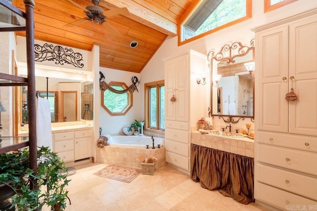 bathroom featuring wood ceiling, a ceiling fan, a bath, two vanities, and lofted ceiling with beams