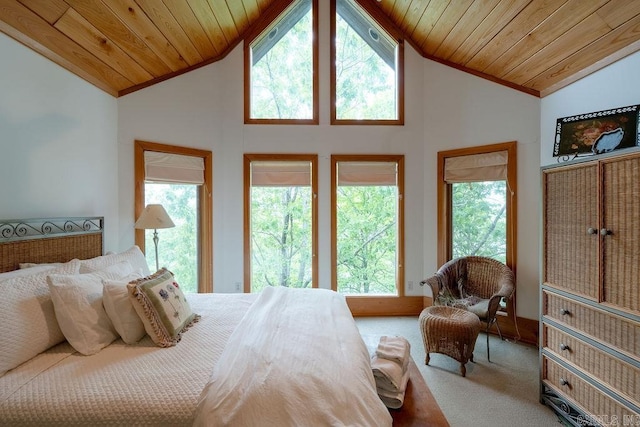 carpeted bedroom featuring vaulted ceiling, ornamental molding, and wood ceiling