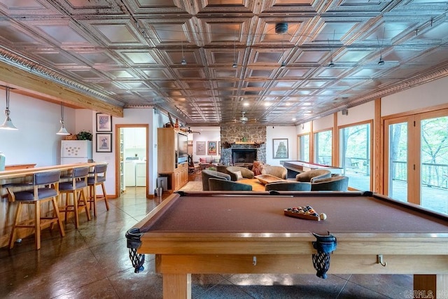 recreation room with an ornate ceiling, pool table, a bar, and a fireplace