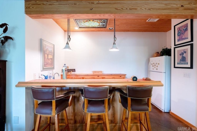 bar with wooden ceiling, baseboards, freestanding refrigerator, and decorative light fixtures