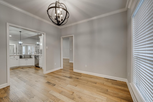 unfurnished dining area with crown molding, baseboards, a chandelier, and light wood-style floors