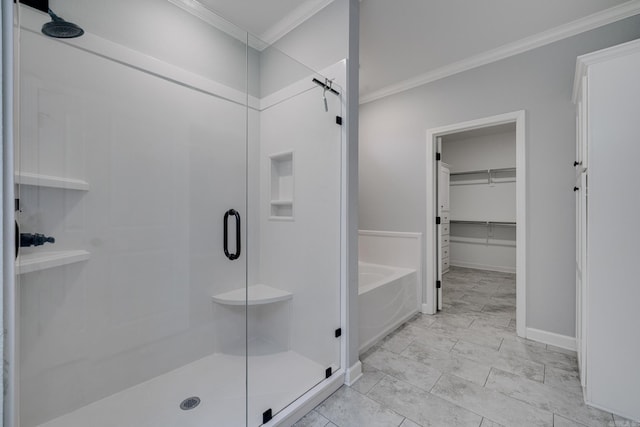 bathroom featuring crown molding, a shower stall, a walk in closet, and a garden tub