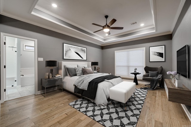 154 Hudson Branch Dr, Austin, AR 72007 - bedroom featuring a tray ceiling, ornamental molding, light wood-style floors, ceiling fan, and connected bathroom