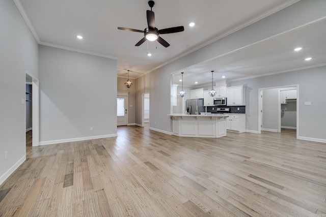 unfurnished living room featuring recessed lighting, ornamental molding, and ceiling fan with notable chandelier