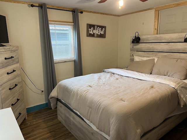 1008 Lange St, Leachville, AR 72438 - bedroom featuring baseboards, a ceiling fan, and dark wood-type flooring