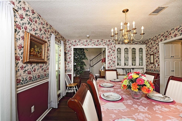 6311 Country Ln, Pine Bluff, AR 71603 - dining room featuring a textured ceiling, visible vents, wood finished floors, a chandelier, and wallpapered walls