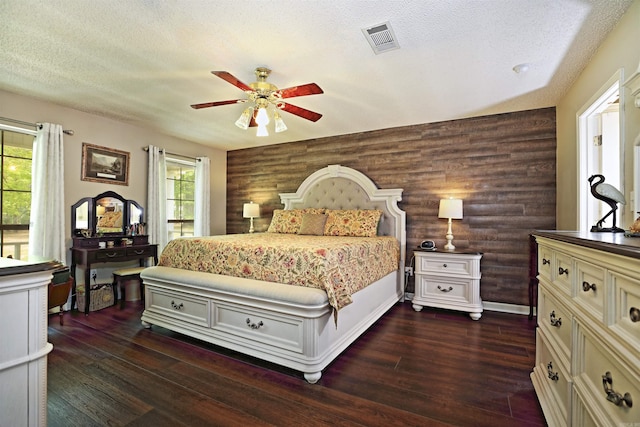 6311 Country Ln, Pine Bluff, AR 71603 - bedroom featuring visible vents, a textured ceiling, ceiling fan, and dark wood-style floors