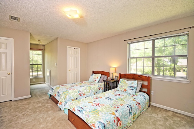 6311 Country Ln, Pine Bluff, AR 71603 - bedroom with carpet floors, a textured ceiling, baseboards, and visible vents