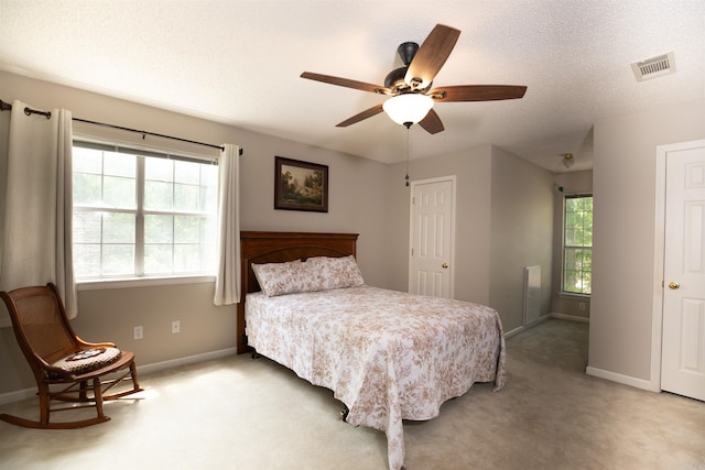 6311 Country Ln, Pine Bluff, AR 71603 - bedroom with baseboards, ceiling fan, light carpet, and visible vents