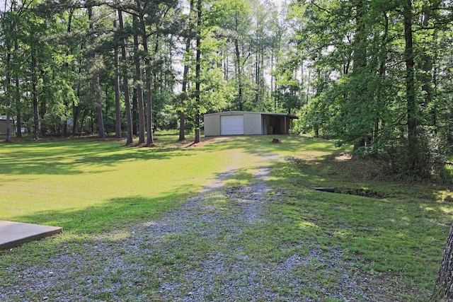 6311 Country Ln, Pine Bluff, AR 71603 - view of yard featuring a detached garage, an outdoor structure, and driveway